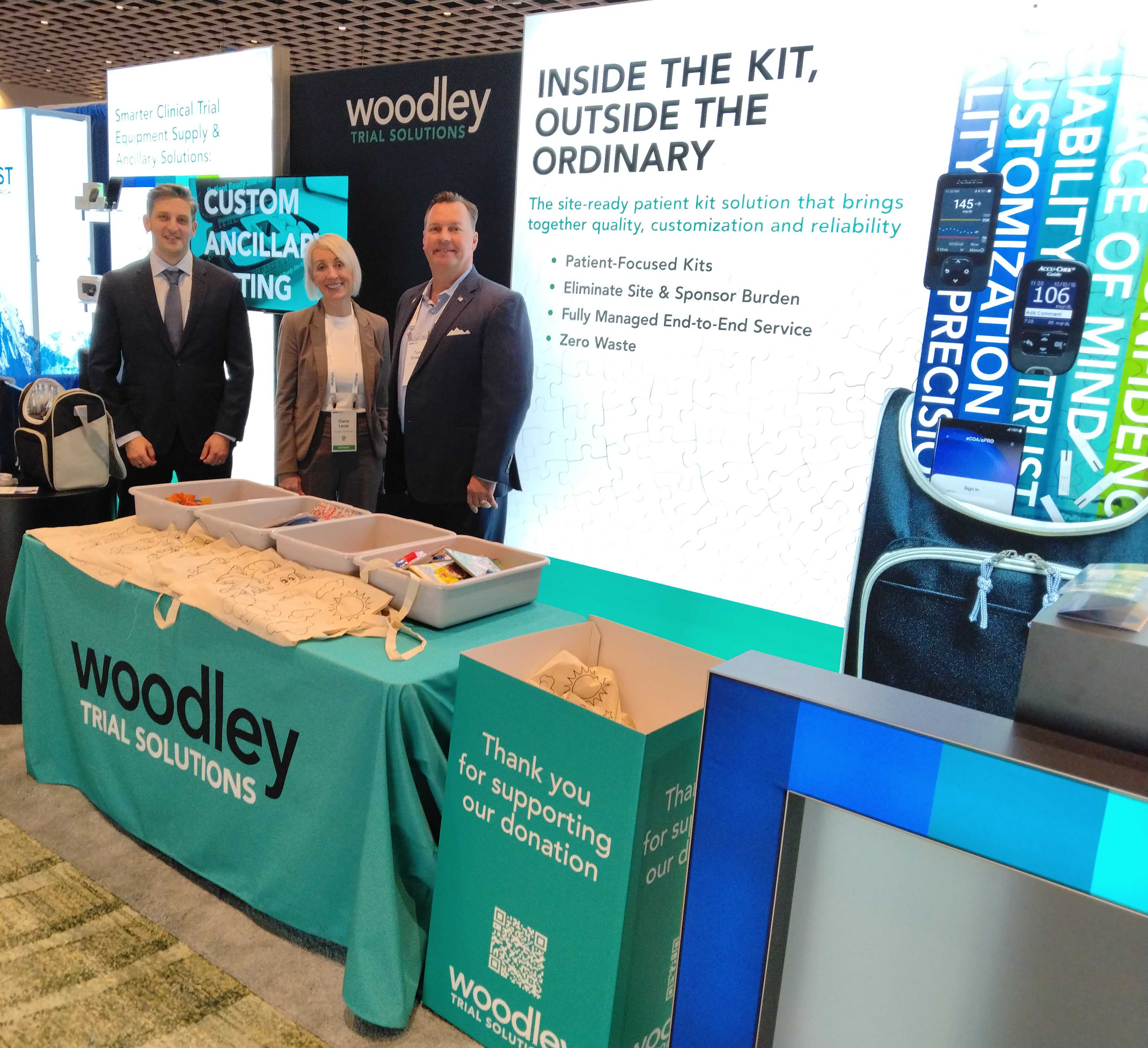 Robin Wickham, Claire Lever and Tom Shadrix with the children's activity kits at SCOPE Summit 2026